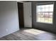 Bedroom with an open closet, window offering outdoor views, and light wood-look floors that brighten the space at 212 Weyburn St., Myrtle Beach, SC 29579