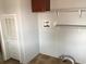 Functional laundry room with washer/dryer hookups, shelving, and tile flooring for easy maintenance and organization at 212 Weyburn St., Myrtle Beach, SC 29579