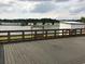 Wooden deck overlooking a serene lake, complete with a swing and relaxing view of houses around the water at 212 Weyburn St., Myrtle Beach, SC 29579
