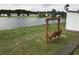 Waterfront wooden deck with beautiful scenery, including a swing, houses, lake and perfect for outdoor enjoyment at 212 Weyburn St., Myrtle Beach, SC 29579