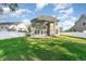 Backyard with an attached home featuring green grass, an open patio, and a white fence at 237 Chesapeake Ln., Murrells Inlet, SC 29576