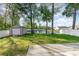 Backyard with a lake view, storage shed, green grass, and a white fence at 237 Chesapeake Ln., Murrells Inlet, SC 29576