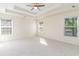 Spacious bedroom with a tray ceiling, neutral carpet and lots of natural light from the windows at 237 Chesapeake Ln., Murrells Inlet, SC 29576