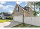 View of the house showing the driveway leading to a two-car garage and fenced in yard at 237 Chesapeake Ln., Murrells Inlet, SC 29576