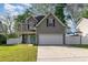 Charming home with a two-car garage, well-kept lawn, and inviting turquoise front door at 237 Chesapeake Ln., Murrells Inlet, SC 29576