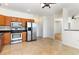 A kitchen with stainless steel appliances and tan tile floors extends into a dining space at 237 Chesapeake Ln., Murrells Inlet, SC 29576