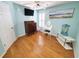 Light and airy bedroom with wood floors and light blue walls, and a TV at 2488 Oriole Dr., Murrells Inlet, SC 29576