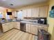 Well-lit kitchen showcasing granite counters, stainless appliances, and wood-look flooring at 2488 Oriole Dr., Murrells Inlet, SC 29576