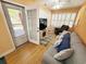 Bright living room with wood floors, grey sofa, and access to outdoor patio at 2488 Oriole Dr., Murrells Inlet, SC 29576