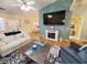 Bright and open living room featuring a large TV, fireplace, and comfortable seating at 2488 Oriole Dr., Murrells Inlet, SC 29576