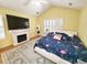 Beautiful bedroom with a flamingo-themed bedspread, white fireplace, and plantation shutters at 2488 Oriole Dr., Murrells Inlet, SC 29576
