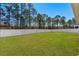 A large, fenced backyard with lush green grass and mature trees at 255 Augusta Green Way, Myrtle Beach, SC 29579