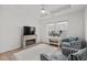 Cozy bedroom with natural light, a tray ceiling, a ceiling fan, and a decorative fireplace at 255 Augusta Green Way, Myrtle Beach, SC 29579