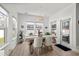 Bright dining area with wood floors, modern lighting, and a view of the landscaped backyard at 255 Augusta Green Way, Myrtle Beach, SC 29579
