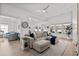 Bright living room with neutral sofa, ceiling fan, and open view into the kitchen at 255 Augusta Green Way, Myrtle Beach, SC 29579
