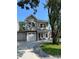 Beautiful exterior elevation with stone accents, attached garages, and a well-manicured lawn at 2601 Sand Dunes Dr., Myrtle Beach, SC 29577