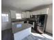 Modern kitchen with stainless steel appliances, granite countertops, and island with sink at 2601 Sand Dunes Dr., Myrtle Beach, SC 29577