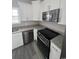 Modern kitchen with stainless steel appliances, granite countertops and white cabinets at 2601 Sand Dunes Dr., Myrtle Beach, SC 29577