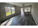 Spacious living room filled with natural light, featuring modern gray floors, ceiling fan and bright walls at 2601 Sand Dunes Dr., Myrtle Beach, SC 29577