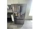 Stainless steel LG refrigerator in a modern kitchen with dark appliances at 2601 Sand Dunes Dr., Myrtle Beach, SC 29577