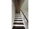 Staircase with white risers and dark wood treads, leading to the upper level of the home at 2601 Sand Dunes Dr., Myrtle Beach, SC 29577