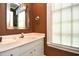 Cozy powder room featuring brown walls and a white vanity at 273 Golden Bear Dr. # F3, Pawleys Island, SC 29585