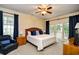 Inviting bedroom features a king bed, ceiling fan, and access to the outdoor balcony at 273 Golden Bear Dr. # F3, Pawleys Island, SC 29585