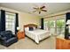 Bedroom features a ceiling fan, king bed, sitting area, and access to a balcony at 273 Golden Bear Dr. # F3, Pawleys Island, SC 29585