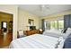 Bright bedroom with a ceiling fan, dresser, access to the deck, and access to adjacent room at 273 Golden Bear Dr. # F3, Pawleys Island, SC 29585
