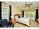 Bedroom features a ceiling fan, king bed, sitting area, and access to a balcony at 273 Golden Bear Dr. # F3, Pawleys Island, SC 29585
