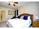 Comfortable bedroom offers a king bed, ceiling fan, and an adjoining bathroom at 273 Golden Bear Dr. # F3, Pawleys Island, SC 29585