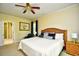 Bedroom featuring a ceiling fan, king bed, and adjacent bathroom with a shower at 273 Golden Bear Dr. # F3, Pawleys Island, SC 29585