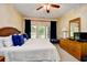 Bright bedroom with a king bed, ceiling fan, dresser, and a balcony view at 273 Golden Bear Dr. # F3, Pawleys Island, SC 29585