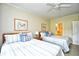 Bright bedroom has two beds, neutral walls, ceiling fan, and carpeted floor at 273 Golden Bear Dr. # F3, Pawleys Island, SC 29585