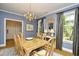 Formal dining room with a chandelier, table with seating for eight, and ample natural light at 273 Golden Bear Dr. # F3, Pawleys Island, SC 29585