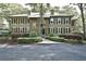 Traditional two-story home boasts a symmetrical design with a brick entryway and lush, manicured landscaping at 273 Golden Bear Dr. # F3, Pawleys Island, SC 29585