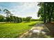 Stunning view of the manicured golf course and walking path surrounded by mature trees and lush greenery at 273 Golden Bear Dr. # F3, Pawleys Island, SC 29585