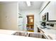 Bright kitchen featuring white cabinetry, stainless steel appliances, and a view into the dining area at 273 Golden Bear Dr. # F3, Pawleys Island, SC 29585