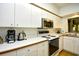 Bright kitchen with white cabinets, modern appliances, and plenty of counter space at 273 Golden Bear Dr. # F3, Pawleys Island, SC 29585