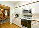 Bright kitchen with white cabinets and stainless steel microwave at 273 Golden Bear Dr. # F3, Pawleys Island, SC 29585