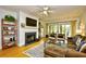 Cozy living room featuring hardwood floors, fireplace, ceiling fan and sliding glass doors at 273 Golden Bear Dr. # F3, Pawleys Island, SC 29585