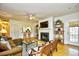 Cozy living room featuring hardwood floors, fireplace, ceiling fan and open bar to kitchen at 273 Golden Bear Dr. # F3, Pawleys Island, SC 29585