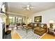 Cozy living room featuring hardwood floors, fireplace, ceiling fan and sliding glass doors at 273 Golden Bear Dr. # F3, Pawleys Island, SC 29585