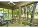 Relaxing screened porch with a ceiling fan and table offering golf course views at 273 Golden Bear Dr. # F3, Pawleys Island, SC 29585