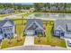Aerial view of a charming home with manicured landscaping, a two-car garage and inviting porch at 296 Switchgrass Loop, Little River, SC 29566