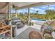 A covered patio with a hot tub, stylish outdoor furniture, and access to a pool at 296 Switchgrass Loop, Little River, SC 29566