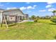 Spacious backyard featuring a swing set, storage shed and patio with pool access at 296 Switchgrass Loop, Little River, SC 29566