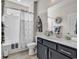 Well-maintained bathroom features vanity with sink and a shower with curtain for privacy at 296 Switchgrass Loop, Little River, SC 29566