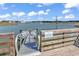 A wooden dock with a metal gangway overlooking a serene lake at 296 Switchgrass Loop, Little River, SC 29566
