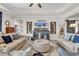 Inviting living room featuring tray ceilings, modern decor, and plenty of seating at 296 Switchgrass Loop, Little River, SC 29566
